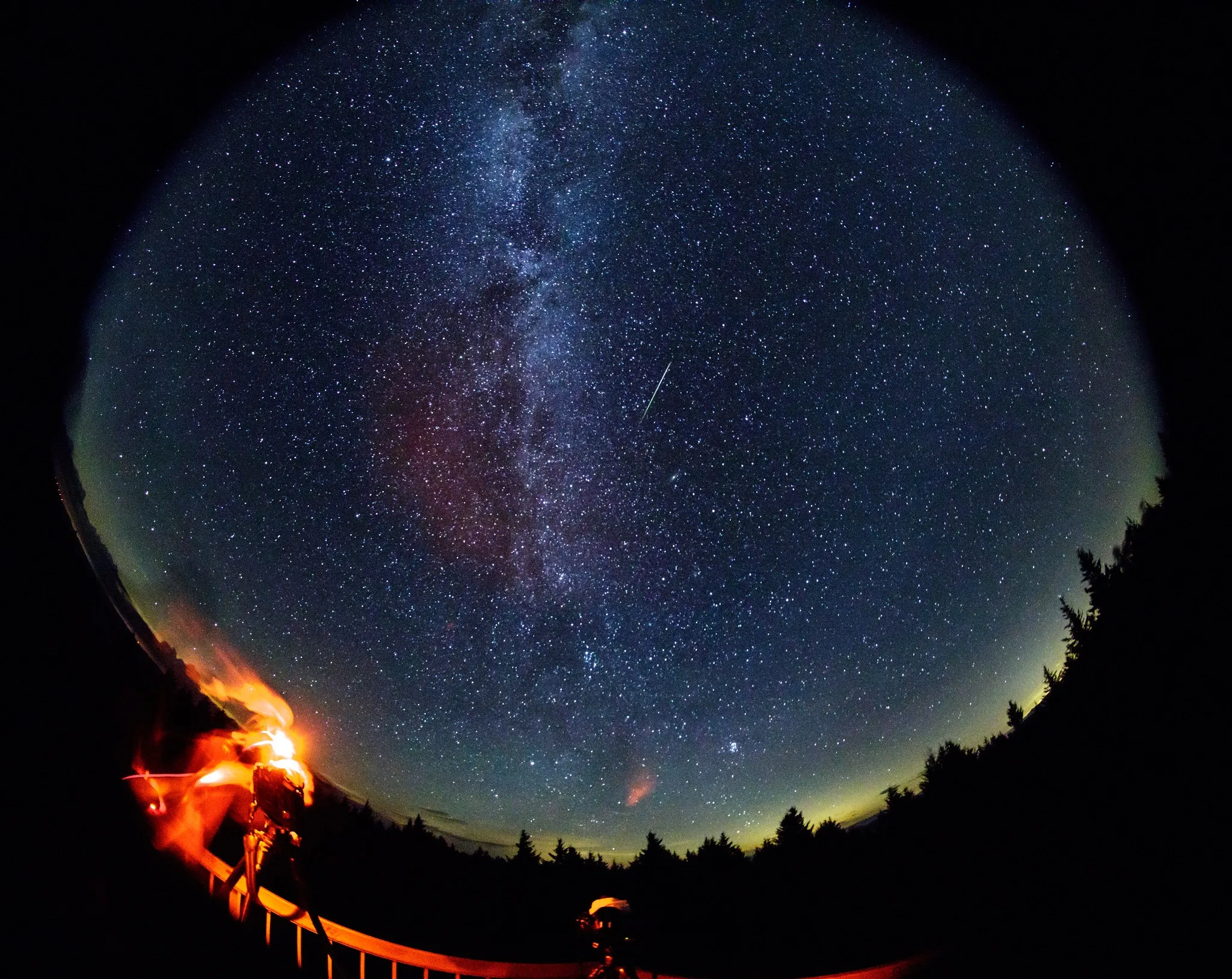 A Perseid meteor streaks across the sky during the annual Perseid meteor shower in 2016